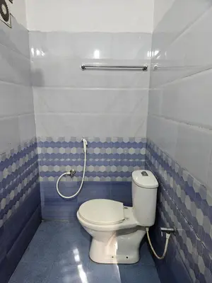 a bathroom with a toilet and a shower at grandresidency in Kāladi