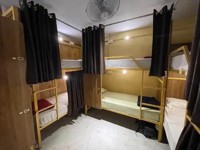 a room with two bunk beds in it at The Marina Kozhikode AC Rooms and Dorms Opposite to Beach in Kozhikode