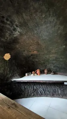 a shelf with vases on it in a room at Mamalakandam Rock Cave at Diya Homestay in Mamalakandam
