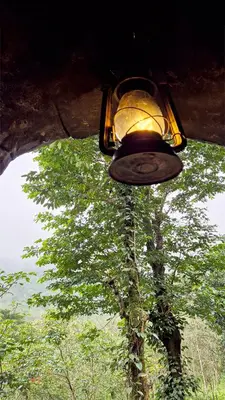 a street light with a tree in the background at Mamalakandam Rock Cave at Diya Homestay in Mamalakandam