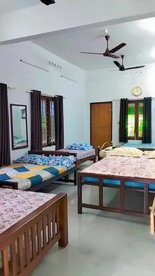 a bedroom with three beds in a room at Mamalakandam Green Hill Stay in Diya Homesay in Mamalakandam