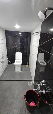 a bathroom with a toilet and a sink at AC 3BHK premium house in Pollāchi