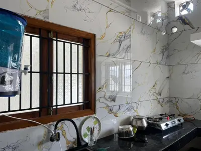 a kitchen with a sink and a window at AC 3BHK premium house in Pollāchi