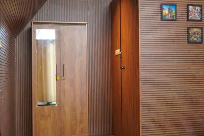 a wooden door in a room with a wall at Airas Resort in Kūkkāl