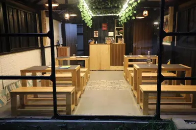 a room with wooden tables and benches in a restaurant at Airas Resort in Kūkkāl