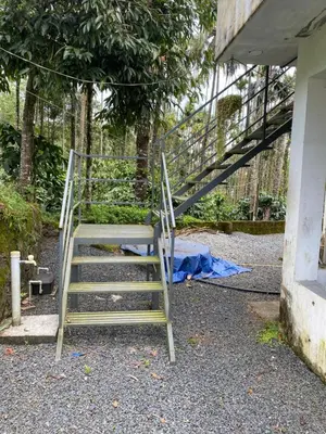 a set of stairs leading up to a house at Travango Settukunnu in Vythiri