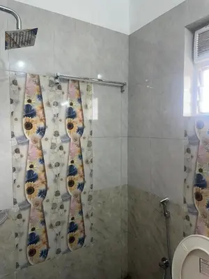 a shower in a bathroom with a shower curtain at Guruvayur Soorya Madhavam Apartment B10, Shruthi, close to Temple, only150 Mtrs to North Nada in Guruvāyūr
