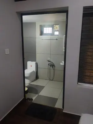 a bathroom with a shower and a toilet at Havence Villas - Kottakkal in Kottakkal