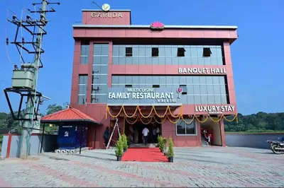 a building with a red carpet in front of it at Ridhis Stay in Virajpet