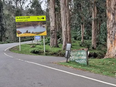 a street sign on the side of a road at Kookal Candle Wood House in Kūkkāl