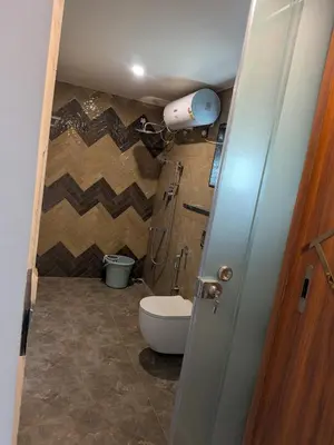 a small bathroom with a toilet and a sink at Auric by Hillton in Mysore