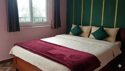 a bed in a room with a window at Hanni Resort in Kotagiri