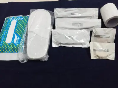 a bag of toilet paper and some rolls of wrapping paper at Hanni Resort in Kotagiri