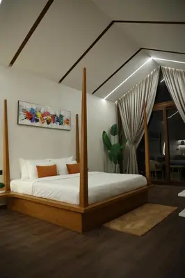 a bedroom with a bed in a room at Hills and Hearts Luxury Villa in Coonoor