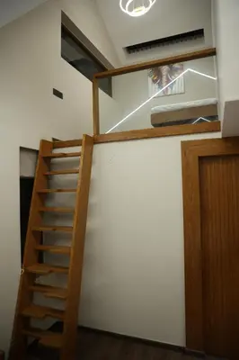 a stairway leading up to a bunk bed in a room at Hills and Hearts Luxury Villa in Coonoor
