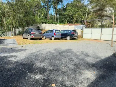a group of three cars parked in a parking lot at Bambus Alley in Wayanad