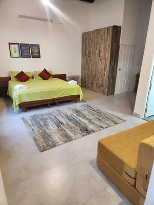 a bedroom with a bed and a rug at The Lake House Ooty in Ooty
