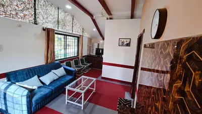 a living room with a blue couch and a fireplace at Nature's Spark Resort in Sivasamudram