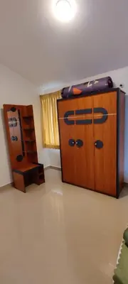 a room with two wooden cabinets and a desk at Noori Home Stay - 2BH in 1st Floor Near Ooty in Ooty