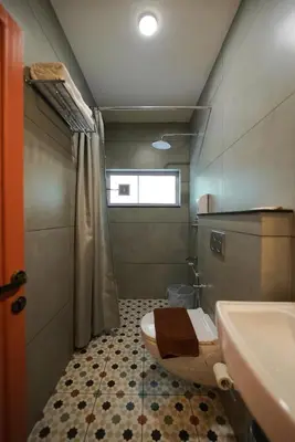a bathroom with a toilet and a sink at Sreenivas Lodge by Copperfolia in Kozhikode