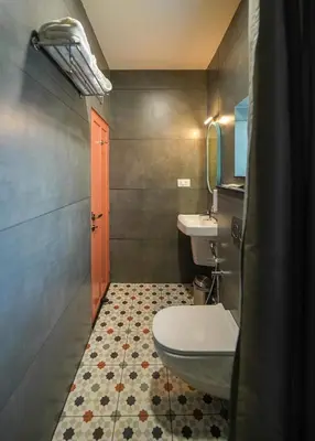 a bathroom with a toilet and a sink at Sreenivas Lodge by Copperfolia in Kozhikode