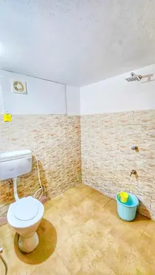 a bathroom with a toilet in a room at TS Club in Trichūr