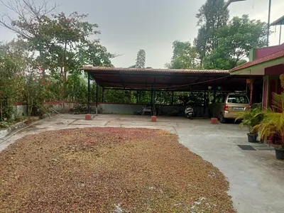 a parking lot with a covering on top of it at Somanna Estate stay in Madikeri