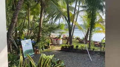 a resort with palm trees and a view of the ocean at Green Island homestay in Kadalundi