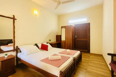 a bedroom with a large bed in a room at Haris Farm House in Kannur