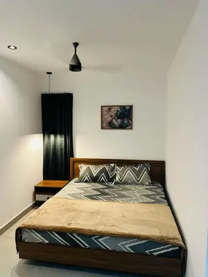 a bedroom with a bed in a room at ZAHIR RESIDENCY calicut in Kozhikode