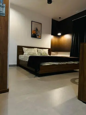 a bedroom with a large bed in a room at ZAHIR RESIDENCY calicut in Kozhikode