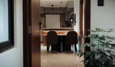a kitchen with a table and two black chairs at French Boulevard in Mahe