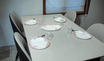 a table with plates and wine glasses on it at French Boulevard in Mahe