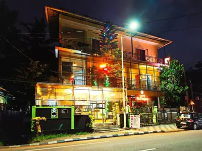 a building with a christmas tree in front of it at RF Tower Lodge in Kozhikode