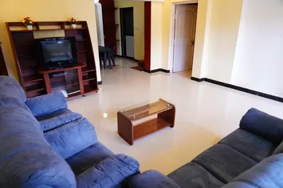 a living room with a couch and a coffee table at KP Holidays తెలుగు Cottage in Ooty