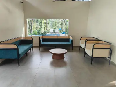 a waiting room with three beds and a table at Half Moon Resort Vythiri by Z Vacations in Vayittiri