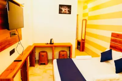 a bedroom with a desk and a bed and a desk at Aps inn munnar in Munnar