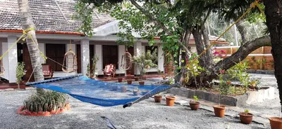 a hammock in the courtyard of a house at 36 Palms Heritage Villa in Cochin