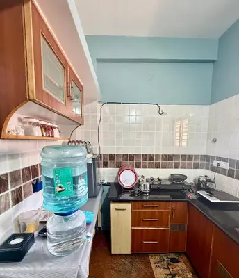 a kitchen with a blender on top of a counter at Anand's Elegant 2BHK Apartment - AC in Mysore