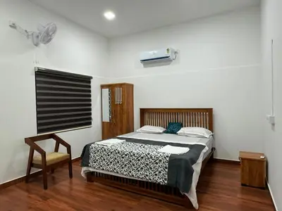 a bedroom with a bed and a chair at Horegallu Homes in Agali