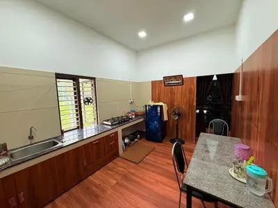 a kitchen with a table and a counter top at Horegallu Homes in Agali