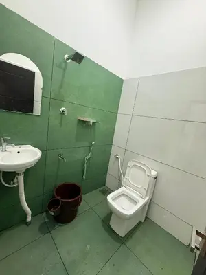 a bathroom with a toilet and a sink at Horegallu Homes in Agali
