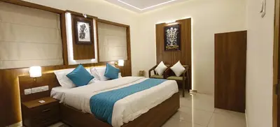 a bedroom with a large bed with blue pillows at Radha Madhavam Apartment's in Guruvāyūr