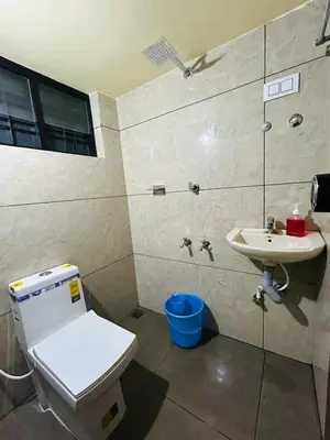 a bathroom with a toilet and a sink at Bluebell Homes A - 3 BHK Near to Calicut in Beypore