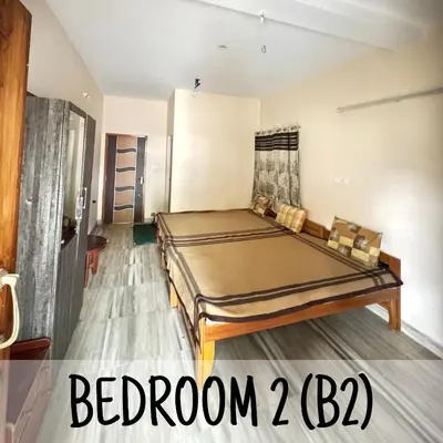 a bedroom with a bed in a room at Ambassador Inn in Kodaikānāl