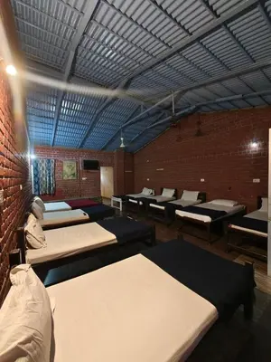 a room with a bunch of beds in it at The Big Cat's Den - Maravakandy Resort, Masinagudi in Masinagudi
