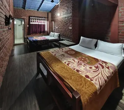a bedroom with a large bed in a brick wall at The Big Cat's Den - Maravakandy Resort, Masinagudi in Masinagudi
