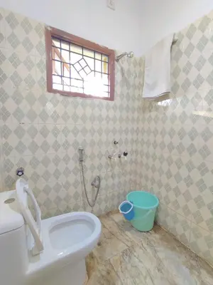 a bathroom with a toilet and a shower at Spacious #3BHK Home Stay in Central Mysore in Mysore