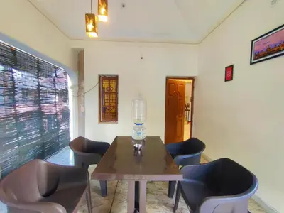 a dining room with a table and chairs at Spacious #3BHK Home Stay in Central Mysore in Mysore