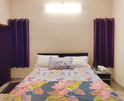 a bedroom with a bed with a colorful comforter at Spacious #1BHK Home Stay in Central #Mysore in Mysore